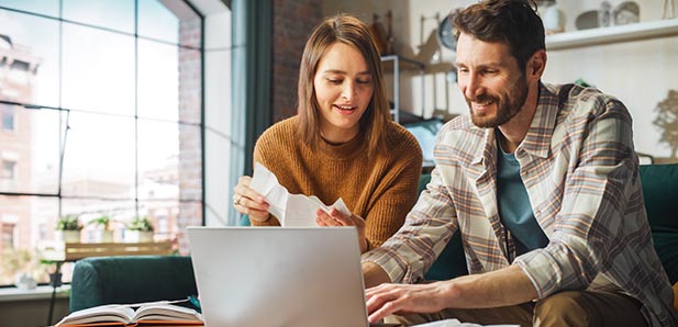 Doing Accounting at Home: Happy Couple Using Laptop Computer, Si