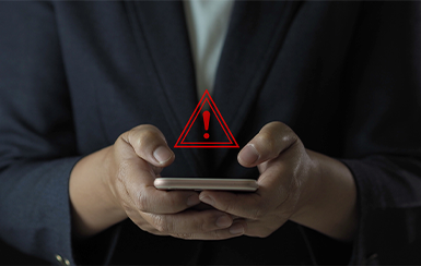image of man holding a phone with an alert