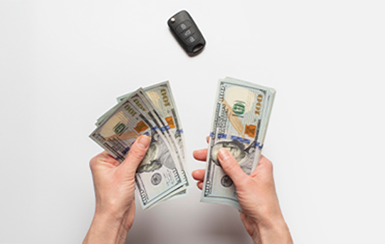 man holding money with car key