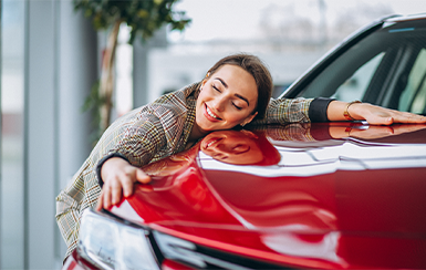 Young Lady laying her head on the car. Happy for Auto Refi
